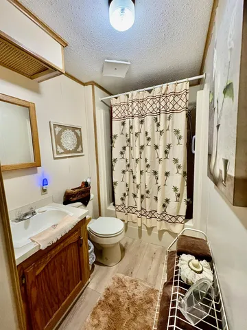 a bedroom with a bed and dresser with mirror
