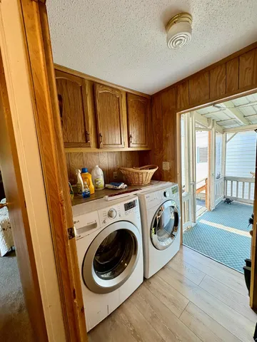 a spacious bedroom with a bed and dresser with mirror