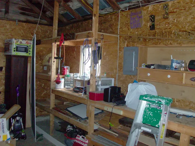 a view of storage and utility room with fridge and rack