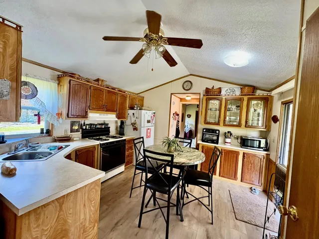 a view of a kitchen with furniture and wooden floor