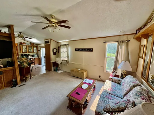 a view of a livingroom with furniture and a ceiling fan