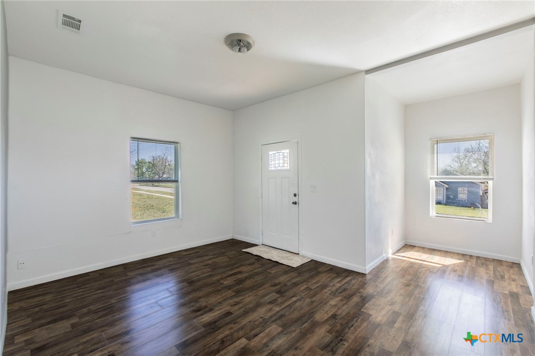 914 South 2nd Street Temple, TX 76504 - Photo 2 of 25 a view of an empty room with wooden floor and a window