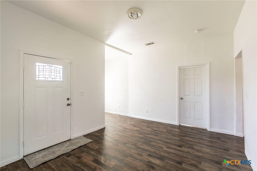914 South 2nd Street Temple, TX 76504 - Photo 3 of 25 a view of an empty room with wooden floor and a window