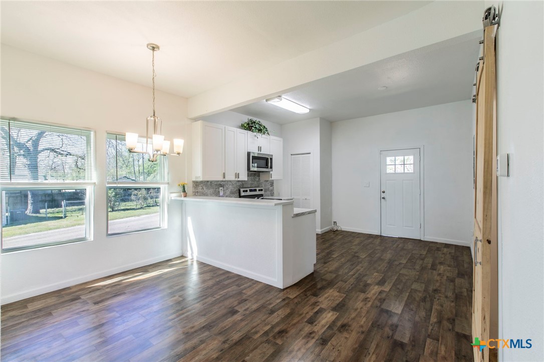 914 South 2nd Street Temple, TX 76504 - Photo 5 of 25 a kitchen with white cabinets and window