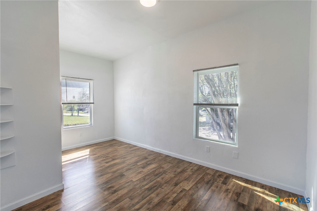 914 South 2nd Street Temple, TX 76504 - Photo 10 of 25 an empty room with wooden floor and windows