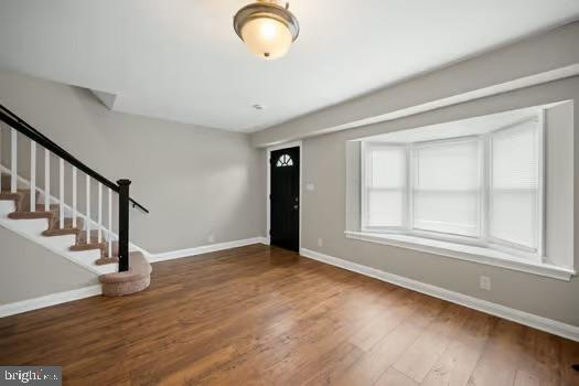 4204 Seidel Avenue Baltimore, MD 21206 - Photo 3 of 23 a view of an empty room with wooden floor and a window