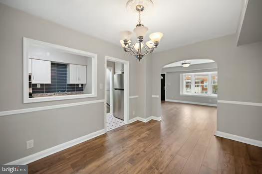 4204 Seidel Avenue Baltimore, MD 21206 - Photo 5 of 23 a view of an empty room with wooden floor and a window