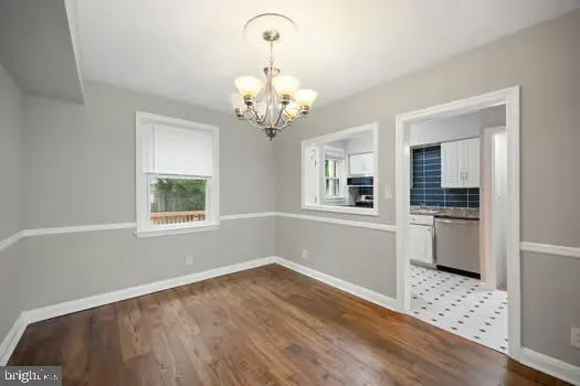 a view of a kitchen with wooden floor and a window