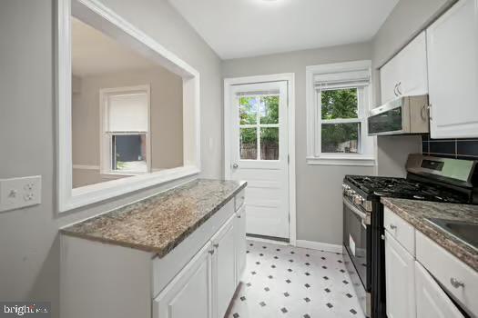 4204 Seidel Avenue Baltimore, MD 21206 - Photo 9 of 23 a kitchen with granite countertop a sink stove and cabinets