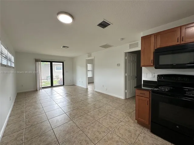 a view of a kitchen with an empty space and a window