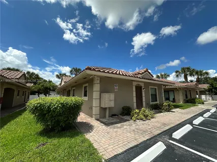 a view of a house with backyard and garden