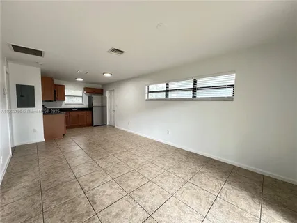 a view of a kitchen with a sink and a refrigerator