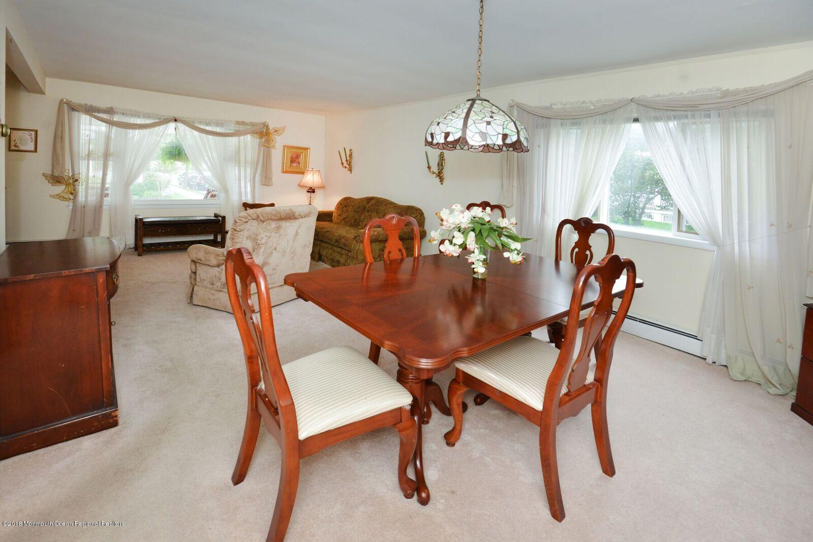 77 Cookman Avenue Ocean Grove, NJ 07756 - Photo 11 of 23 a dining room with furniture a chandelier and window
