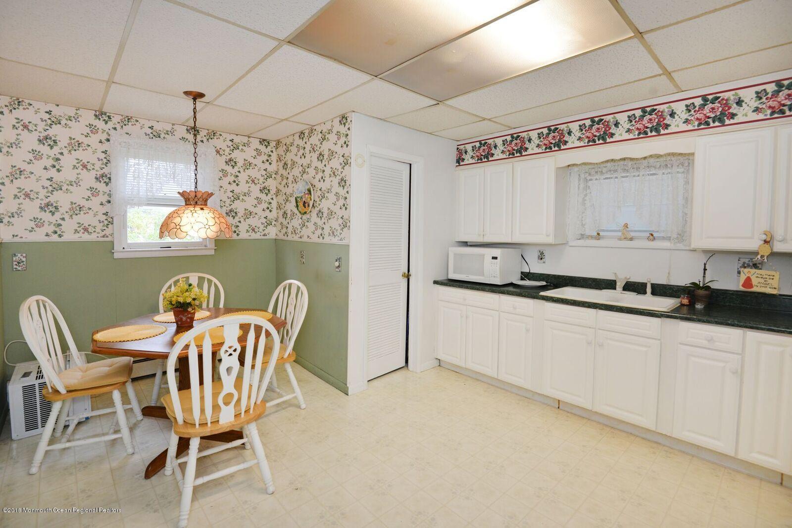 77 Cookman Avenue Ocean Grove, NJ 07756 - Photo 12 of 23 a table and chairs in a kitchen