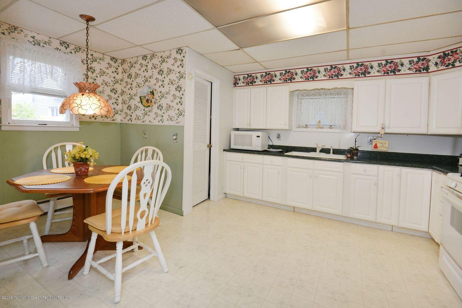 77 Cookman Avenue Ocean Grove, NJ 07756 - Photo 13 of 23 a kitchen with stainless steel appliances granite countertop a sink and a refrigerator