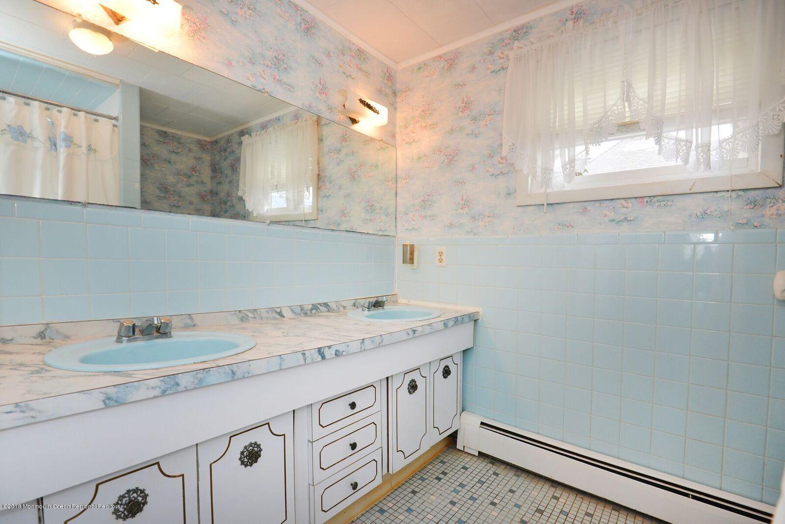 77 Cookman Avenue Ocean Grove, NJ 07756 - Photo 16 of 23 a bathroom with a sink a vanity and a mirror