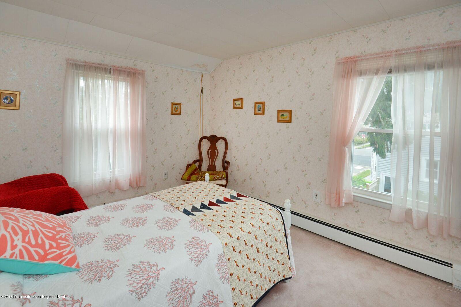77 Cookman Avenue Ocean Grove, NJ 07756 - Photo 19 of 23 a bedroom with a bed and a window