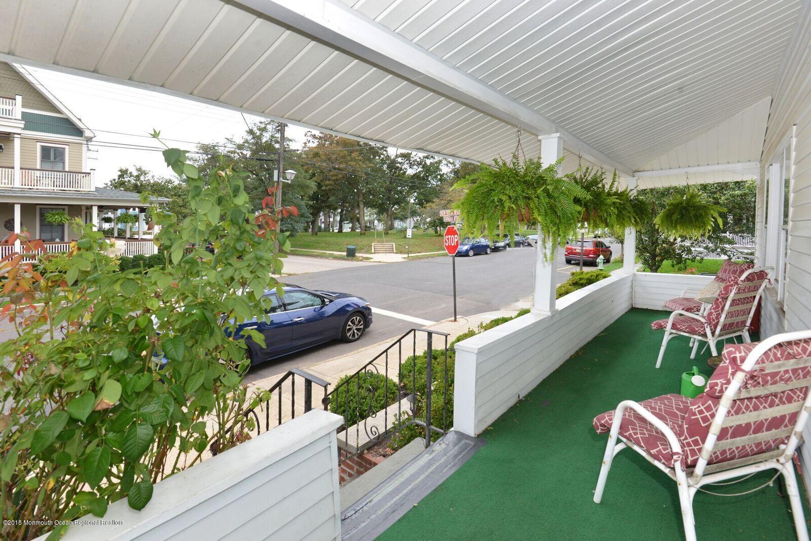 77 Cookman Avenue Ocean Grove, NJ 07756 - Photo 3 of 23 a view of a patio with table and chairs potted plants with wooden floor