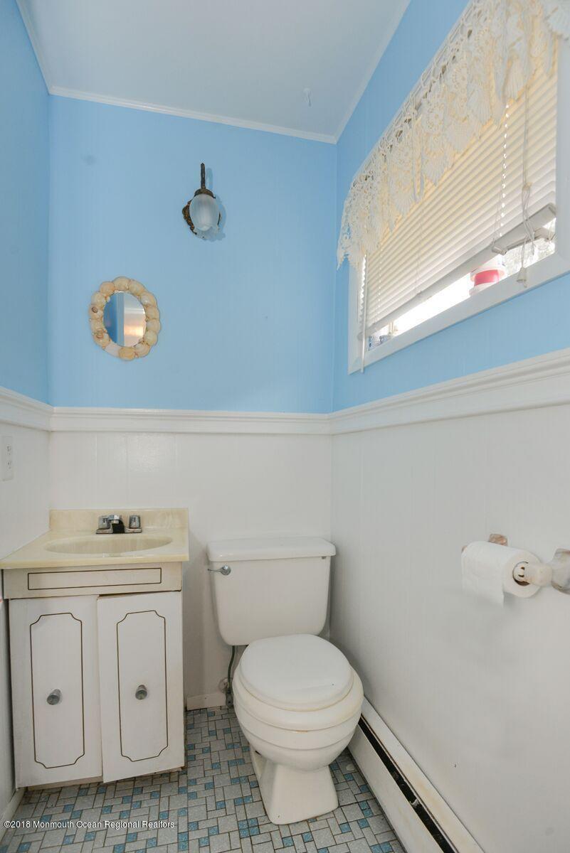 77 Cookman Avenue Ocean Grove, NJ 07756 - Photo 8 of 23 a bathroom with a toilet a sink and a window