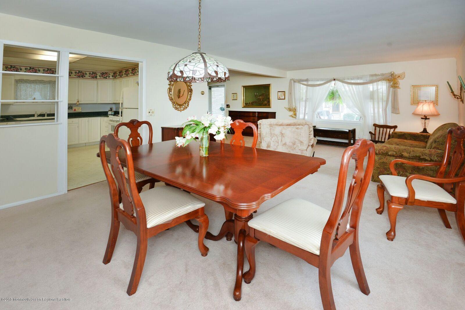 77 Cookman Avenue Ocean Grove, NJ 07756 - Photo 10 of 23 a dining room with furniture a chandelier and wooden floor
