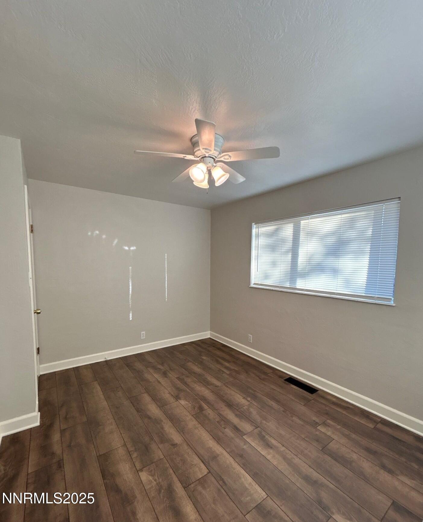 660 Kirman Avenue Reno, NV 89502 - Photo 14 of 17 an empty room with wooden floor and windows