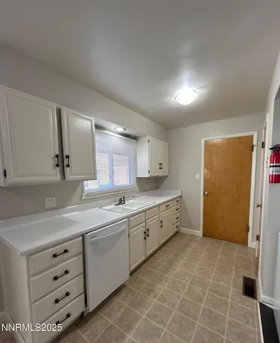 a large bathroom with a large mirror vanity and a sink