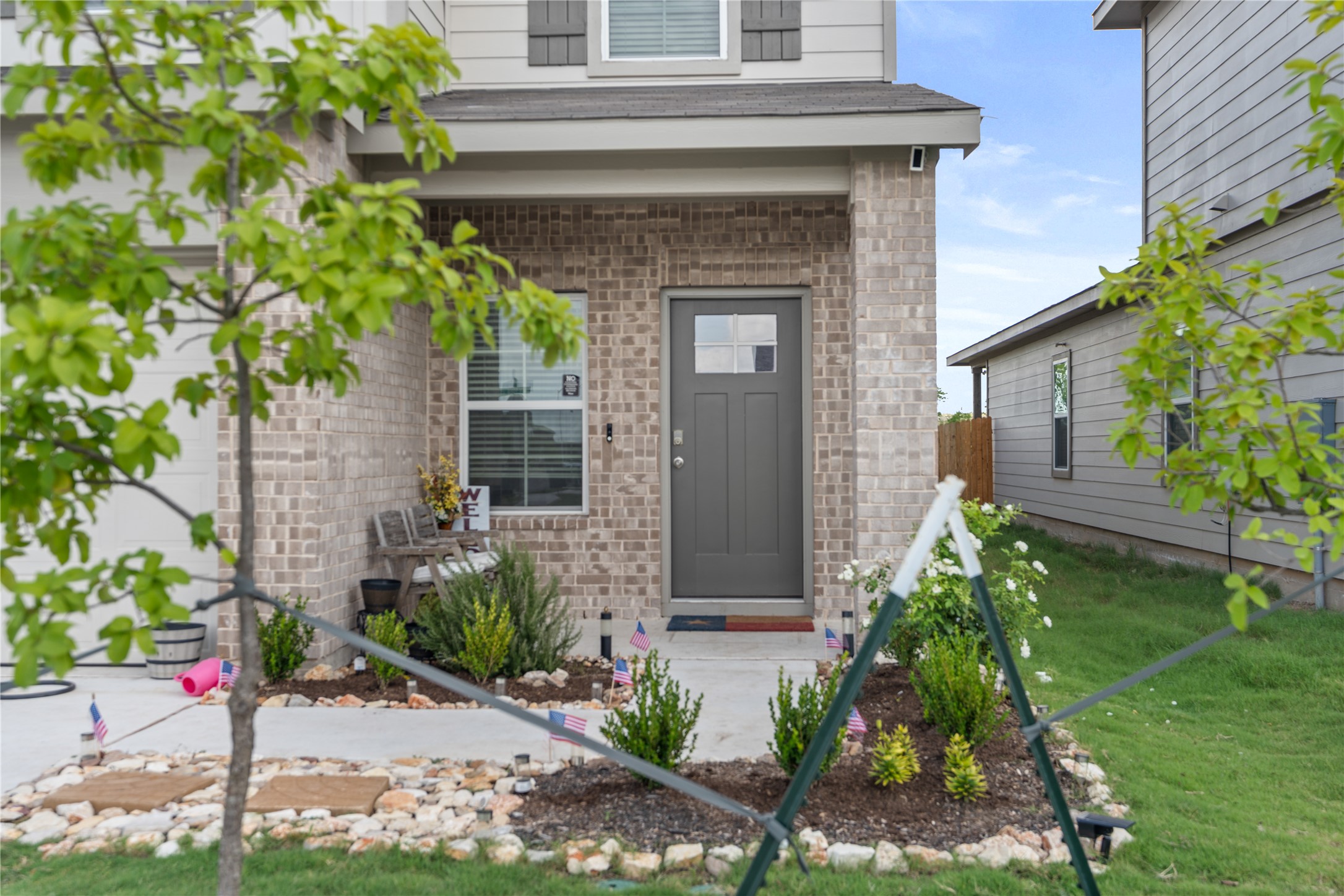 143 Santa Rosa Lane Buda, TX 78610 - Photo 2 of 28 Property entrance with brick siding and a yard