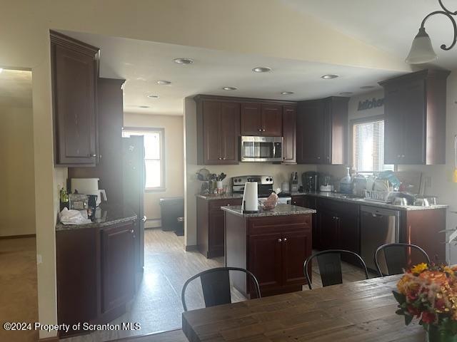 1543 Sanderson Avenue, Unit 2B Scranton, PA 18509 - Photo 3 of 7 a kitchen with stainless steel appliances granite countertop a refrigerator a stove top oven a sink dishwasher and white cabinets with wooden floor