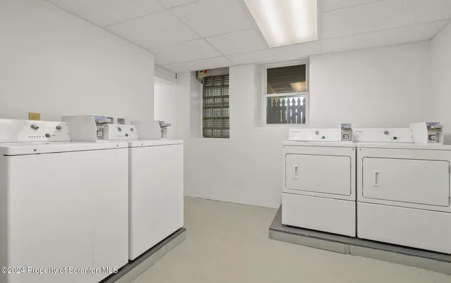 a utility room with cabinets washer and dryer