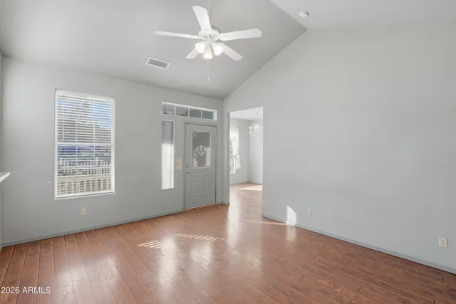 wooden floor in an empty room with a window