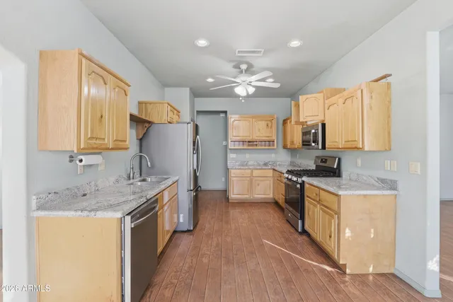 a kitchen with a sink stove top oven and refrigerator