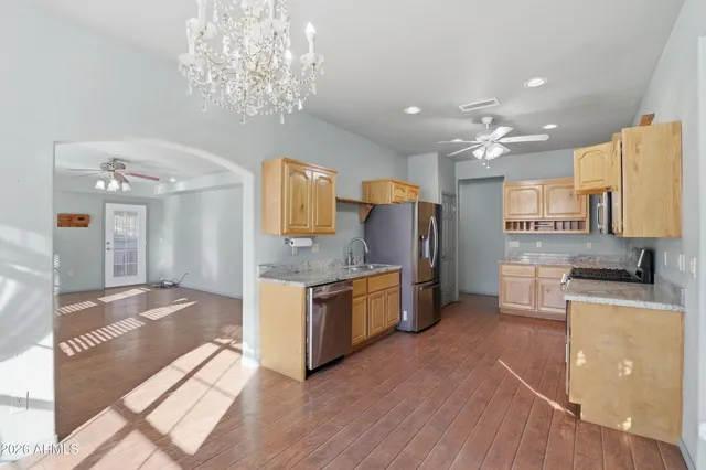 a kitchen with granite countertop a stove oven and refrigerator