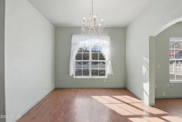an empty room with windows and entrance