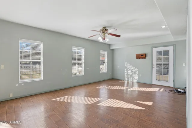 a view of livingroom with hardwood floor and a ceiling fan