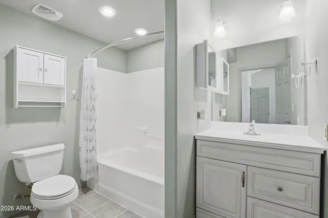 a bathroom with a sink toilet vanity and shower