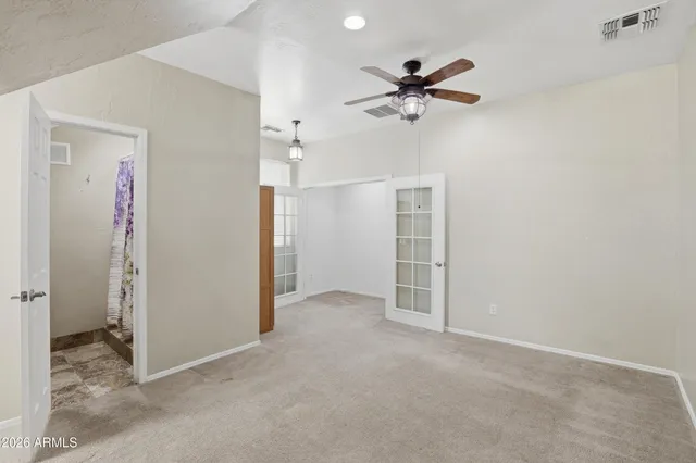 a view of a livingroom with a ceiling fan and closet area