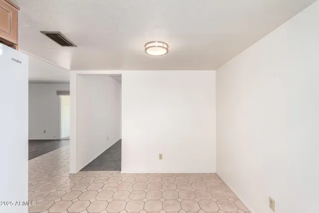 a kitchen with white cabinets appliances a sink and a window