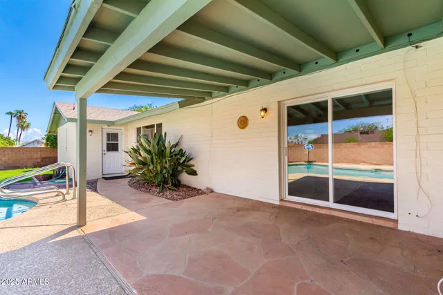 a front view of house with yard and swimming pool