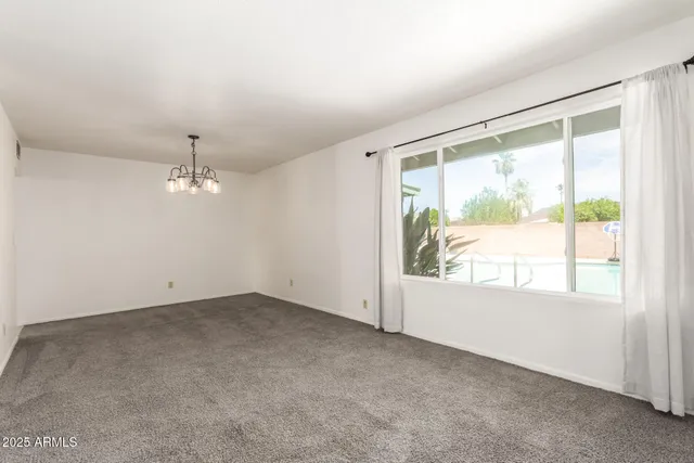 an empty room with a empty space and windows