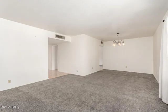 a view of a chandelier in big room and hallway