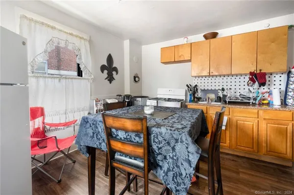 a outdoor dining space with furniture and wooden floor