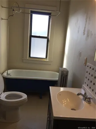 a bathroom with a sink a toilet and a bathtub