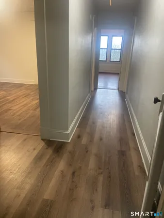 a view of wooden floor and windows in a room