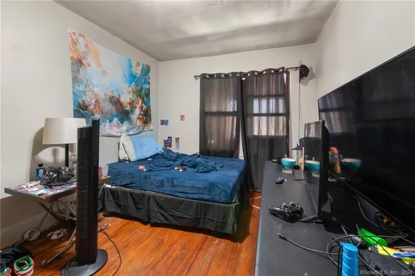 a bed room with a bed and a television