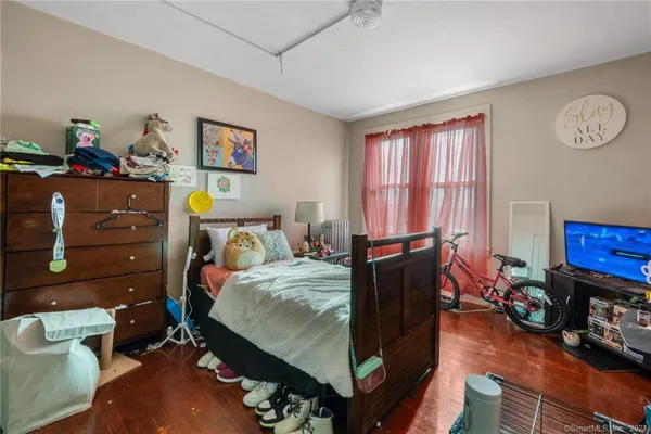 a bedroom with bed and a window