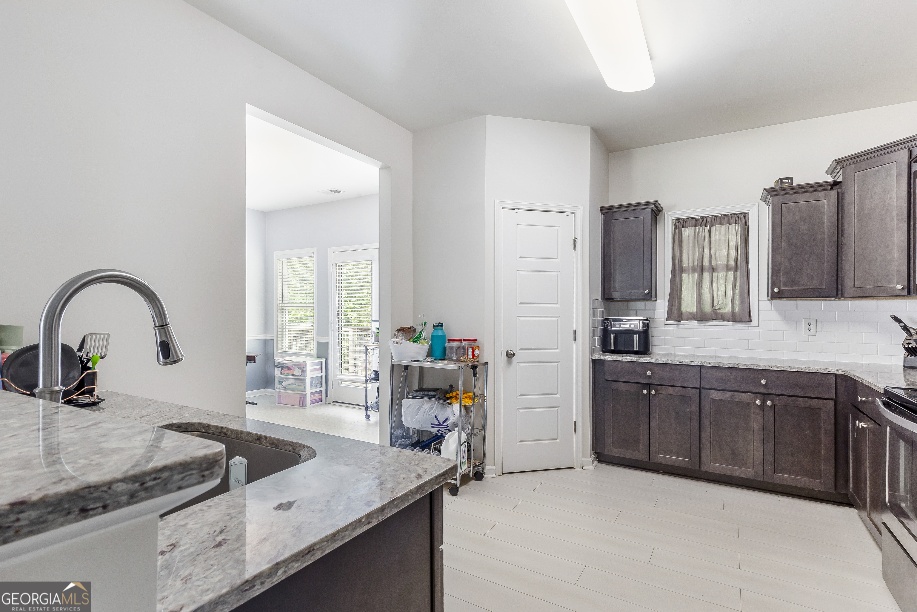 370 Springwater Way Bremen, GA 30110 - Photo 10 of 32 a kitchen with granite countertop a sink and wooden cabinets