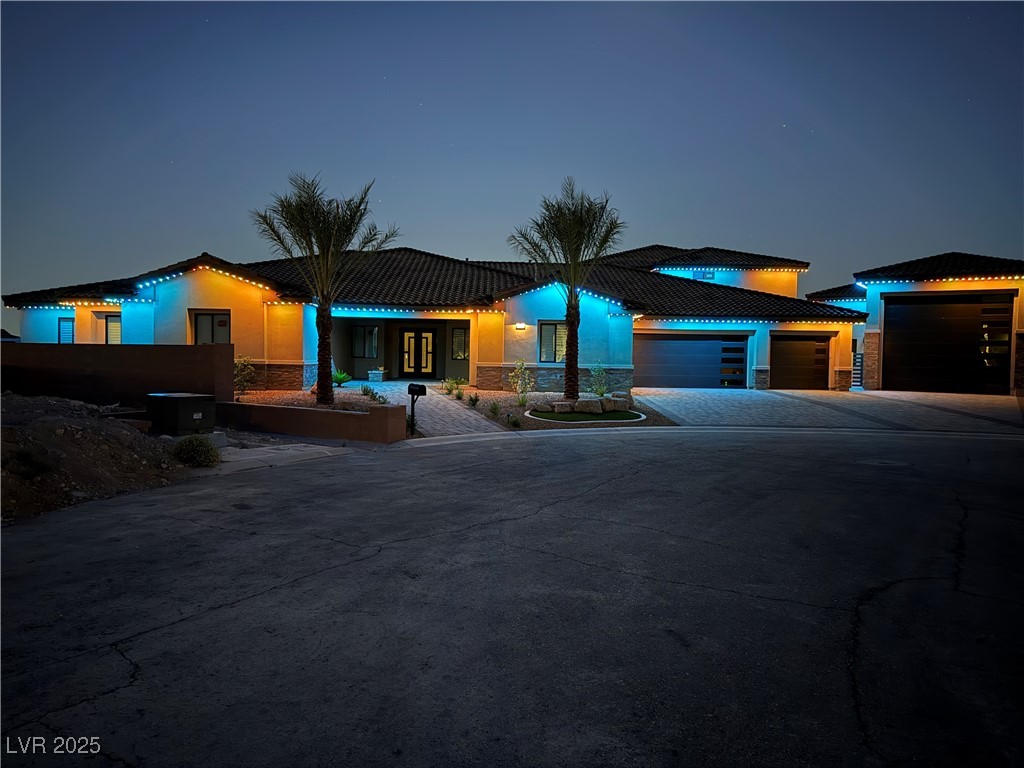 9865 Bright Angel Way Las Vegas, NV 89149 - Photo 13 of 98 View of front of property featuring driveway, an attached garage, and stone siding