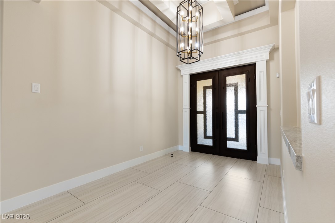 9865 Bright Angel Way Las Vegas, NV 89149 - Photo 18 of 98 Foyer featuring french doors, a chandelier, baseboards, and coffered ceiling