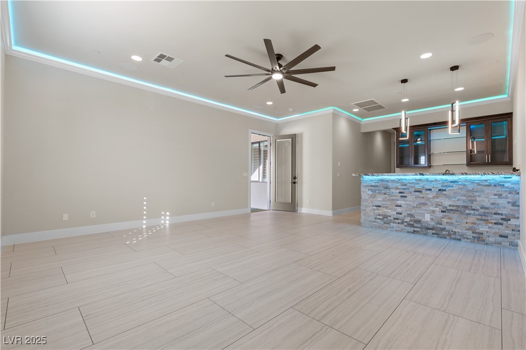 9865 Bright Angel Way Las Vegas, NV 89149 - Photo 34 of 98 Unfurnished living room featuring a ceiling fan, ornamental molding, baseboards, and recessed lighting