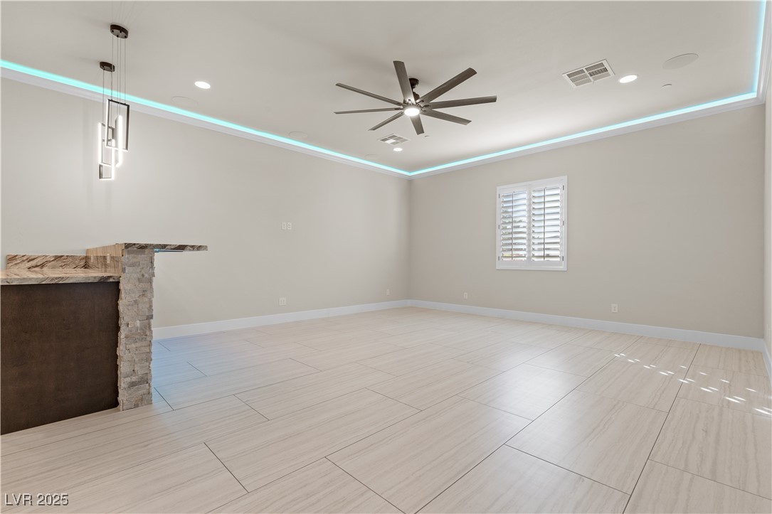 9865 Bright Angel Way Las Vegas, NV 89149 - Photo 35 of 98 Unfurnished living room featuring a ceiling fan, a fireplace, baseboards, and recessed lighting